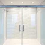 Showcasing sliding shower doors, emphasizing elegant design and modern aesthetics in a sleek bathroom.
