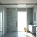 Stylish shower sliding doors featured in a modern bathroom design with natural lighting.