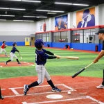 Hitclub athletes training in a modern baseball facility, showcasing energy and advanced equipment.