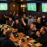 KQBD sports betting scene with fans celebrating and engaging with live match action
