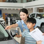 Family reviewing a car history check UK report at a dealership.